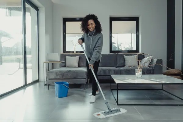 Cleaner vacuuming a furnished private home